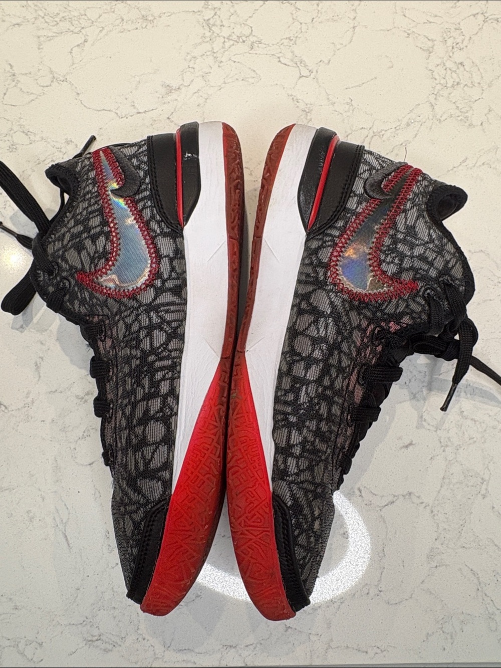 Nike Kids Black and Red Sneakers with Iridescent Swoosh